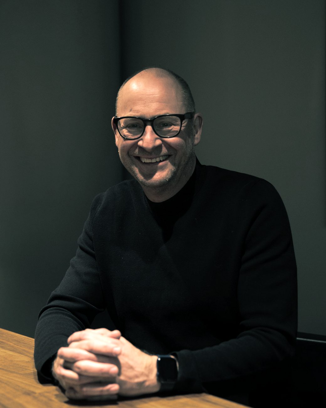 Magnus Burvall, founder of Syntesia, seated at a wooden table and smiling